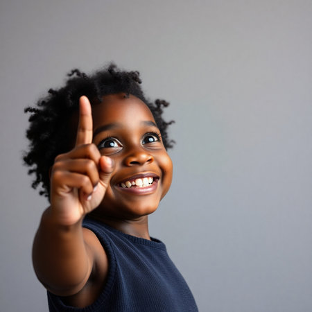 Cheerful african american little girl with thumbs up gestureの素材