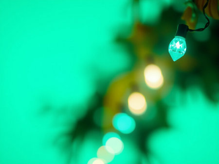 Christmas lights on a green background with bokeh effect. Christmas backgroundの素材