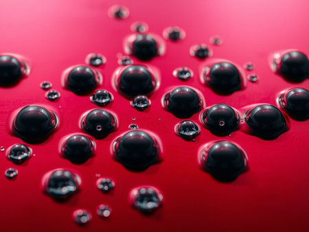 Water drops on a red background. Shallow depth of field.の素材