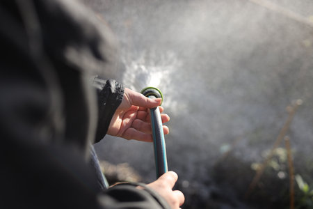 Spraying water from a sprinkler in the garden. Selective focus.の素材