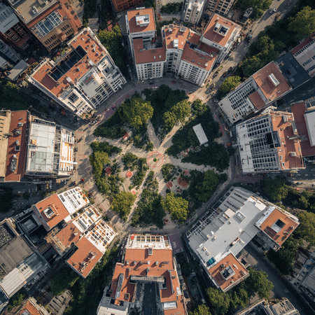 Aerial city view with crossroads and roads, houses, buildings, parks and parking lots. Sunny summer panoramic imageの素材