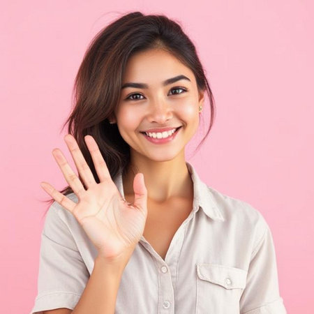 Portrait of a beautiful young Asian woman showing ok sign over pink backgroundの素材