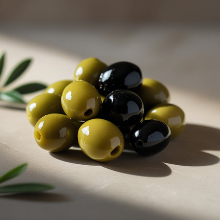 Black and green olives with olive branch on wooden table, closeupの素材