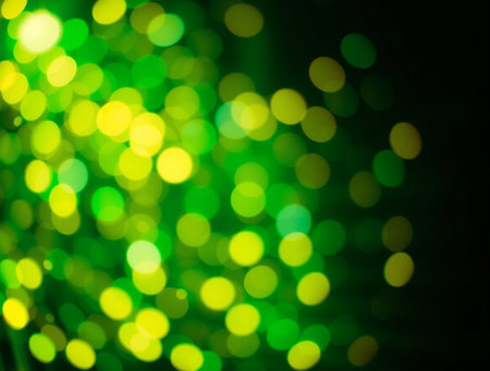 Abstract circular bokeh background of Christmaslight green and yellow colorの素材