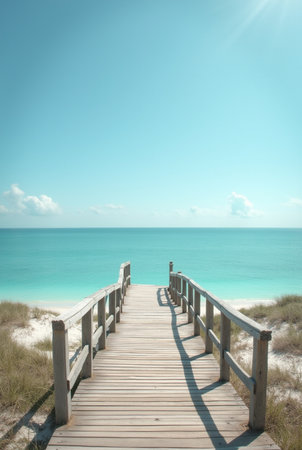Wooden walkway leading to the beach with blue sky and white cloudsの素材