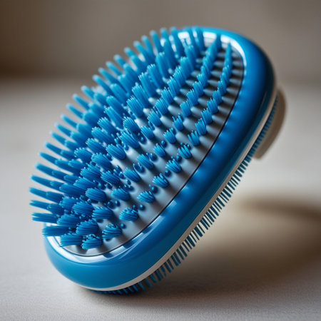 Blue hair brush on a white background. Shallow depth of field.の素材