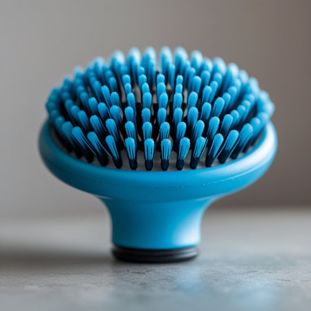 Blue plastic hair brush on gray background. Close up. Shallow depth of field.の素材
