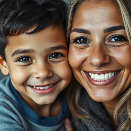 Close up portrait of a smiling mother and son looking at camera togetherの素材