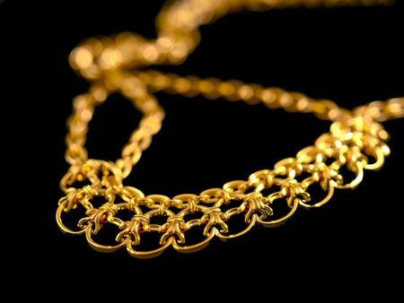 gold necklace on a black background close-up. jewelry photo.の素材