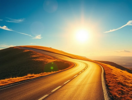 Asphalt road on the hillside in the rays of the rising sunの素材
