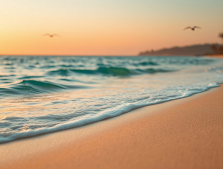 Soft wave of the sea on the sandy beach at sunset background.の素材
