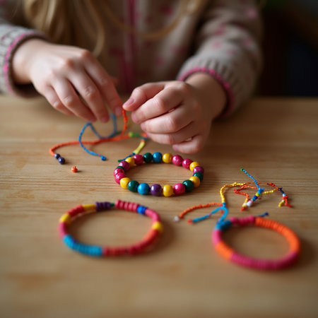 Little girl playing with colorful beads on a wooden table, selective focusの素材