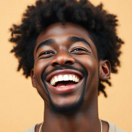 Portrait of young African American man laughing against brown backgroundの素材