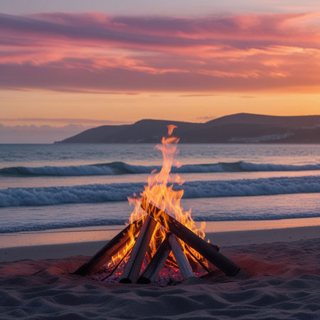 Bonfire on the beach at sunset with a view of the mountainsの素材