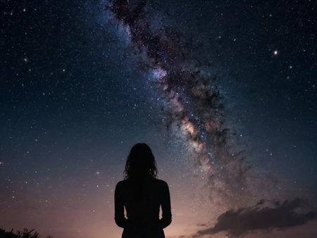 Silhouette of a woman looking at the milky way galaxy.の素材