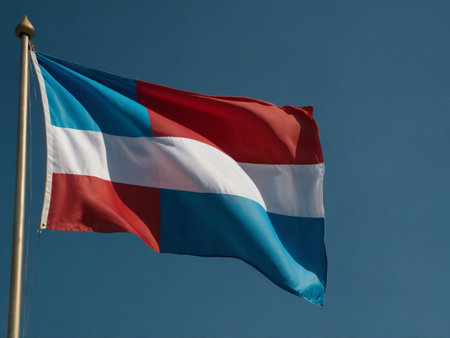 National flag of Luxembourg waving in the wind against the blue sky.の素材