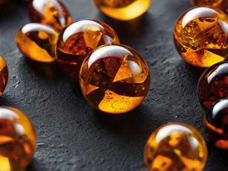 Close up view of a group of amber stones on a black background.の素材