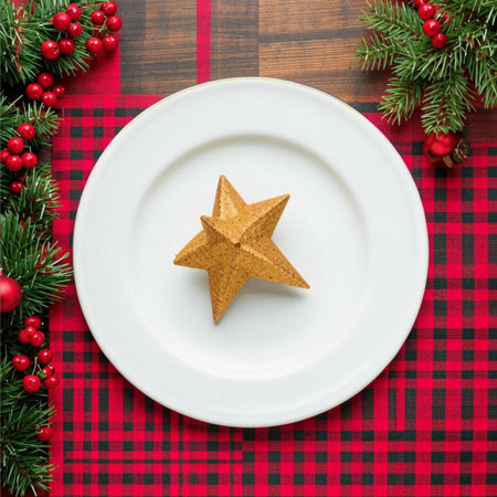 Christmas table setting with christmas tree and star shaped cookie on plateの素材