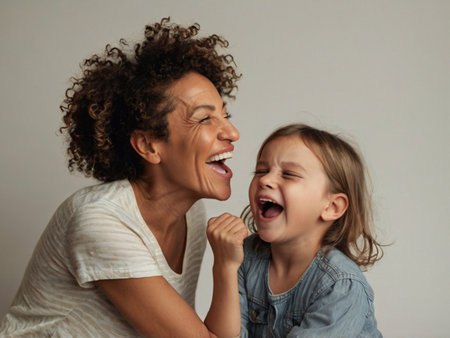 Portrait of a happy mother and her little daughter laughing together.の素材