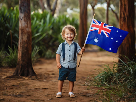 Adorable little boy holding Australia flag in the park. Australian travel concept.の素材