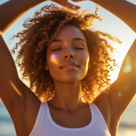 Young african american woman with afro hairstyle and closed eyes on sunset background.の素材