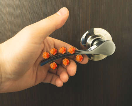 Viruses on the door handle. The concept of microbes sitting on the door handle.の写真素材