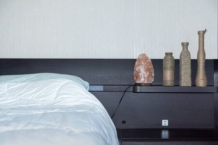 bedroom interior decoration with a night light in the form of a piece of rock salt and decorative dishesの写真素材