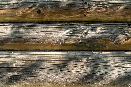 Wooden wall from logs as a background texture closeupの写真素材