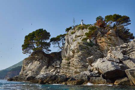Small stone Islands in the sea with a lighthouse.の写真素材