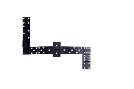 black Domino dice on a white table, the process of playing dominoes. Close up. Selective focus.の写真素材