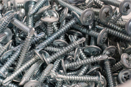 self-tapping steel screws for metal closeup backgroundの写真素材