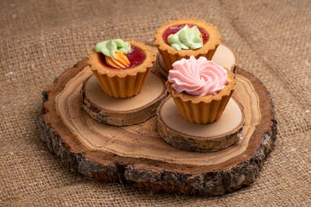 three cakes are placed on stands made of natural wood. Selective Focusの写真素材