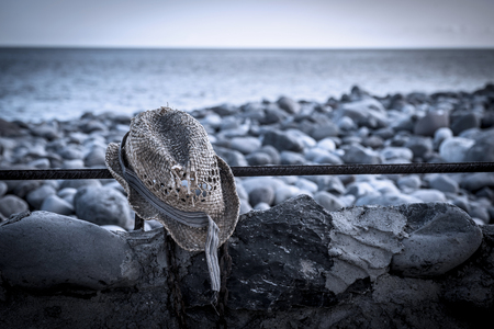 Torn hat on the beachの写真素材