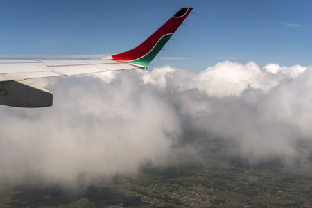 A view of an airplane flying low on the ground