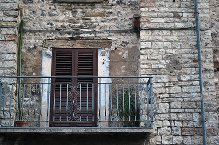 Old chic blue balcony on a stone house in a small town in central Italyの写真素材