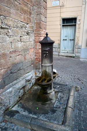 Historic pump on the square of an ancient townの写真素材