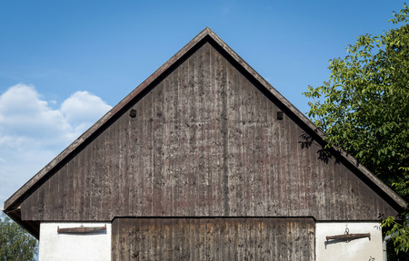 A beautiful wooden roof and wooden ornaments on the white wallの写真素材