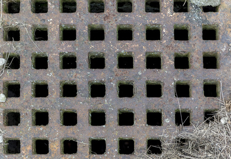 Rusty old iron grid on the canalの写真素材
