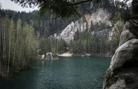and lake with clear blue water between white rocks and forests in the Adrspach rocksの写真素材