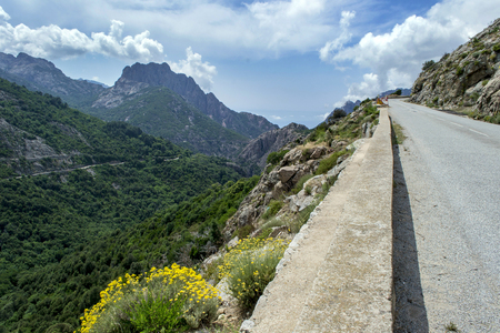 and a narrow road in the high mountains in the interior of the island of Corsicaの写真素材