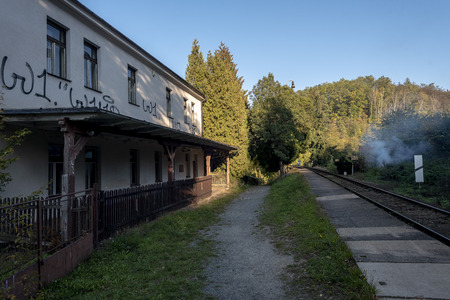 An old railway station with a painted building at the railroad in the forestの写真素材