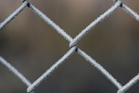 detail of a fence covered with morning frostの写真素材