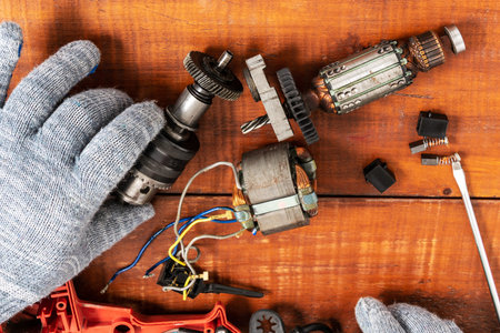 Technician repairs old electric drill