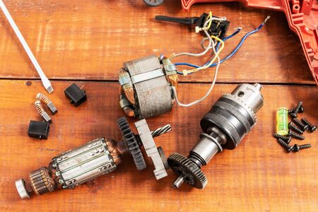 Technician repairs old electric drillの写真素材
