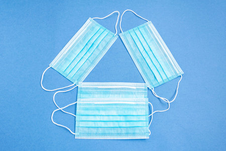 Three protective masksl on a blue background.