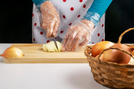 A woman cuts a bow on a wooden board