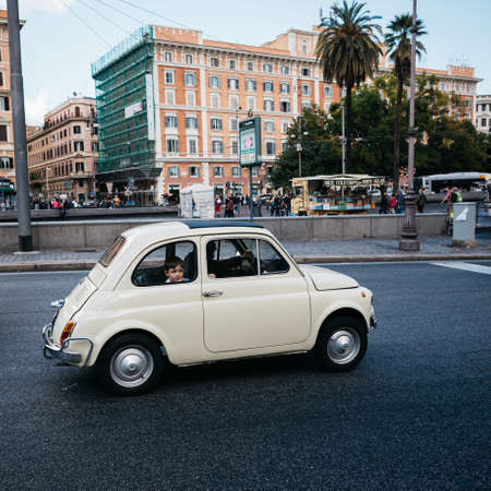 Milan, Italy. May, 2020. Sad little boy in the window of a passing retro car.のeditorial素材