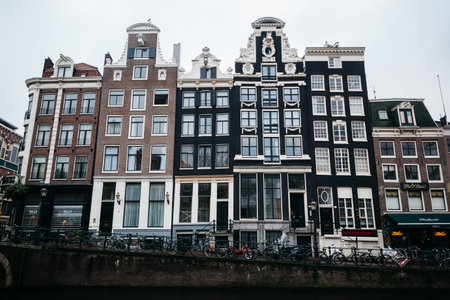 Beautiful houses on the waterfront in Amsterdam. Lots of bikes in the Netherlands.の写真素材