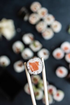 Roll with salmon in sushi sticksの写真素材