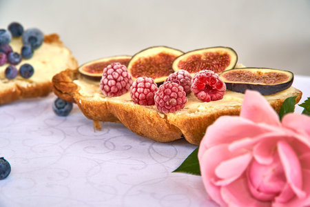 Croissant toast with butter and figs. French dip with raspberries for Breakfast.
